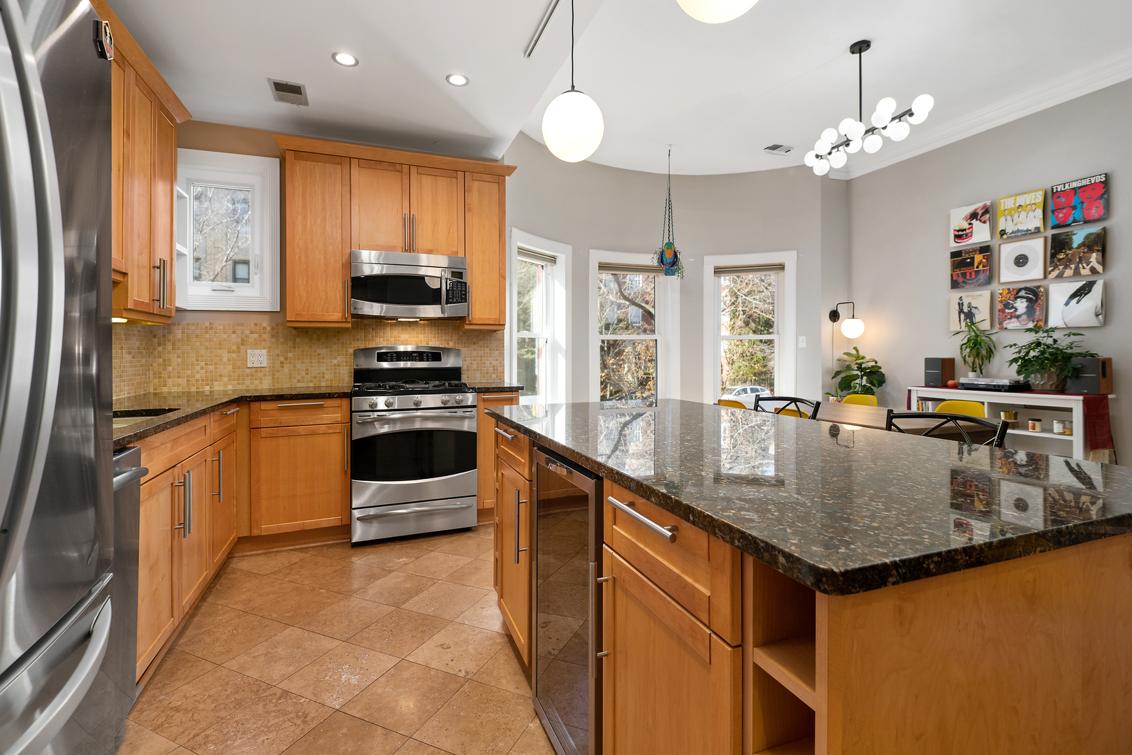 4061 North Sheridan Road, Unit 1 Chicago, IL 60613 - Photo 9 of 26 a kitchen with stainless steel appliances granite countertop a sink stove and refrigerator