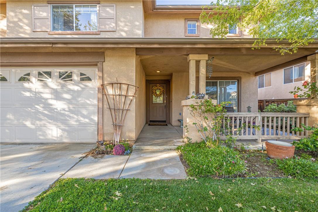 a view of house with a yard and table and chair