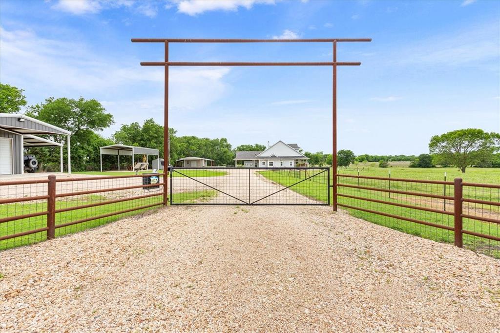 259 County Road 149 Riesel, TX 76682 - Photo 3 of 40 View of dirt / gravel road featuring a gate and a gated entry