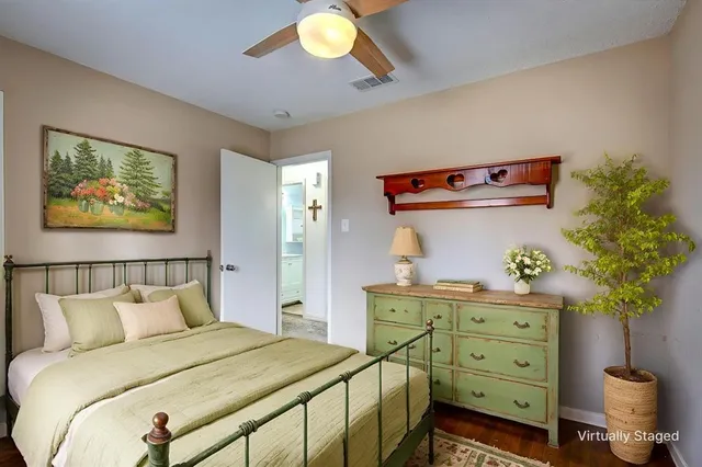 a bedroom with a bed and a potted plant