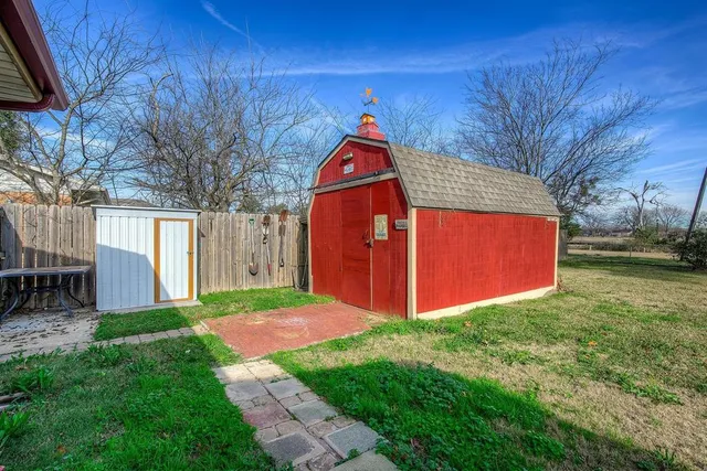 a view of a backyard with a barn