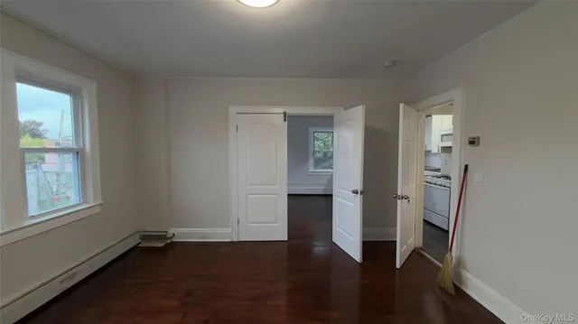 a kitchen with granite countertop a sink stove and cabinets