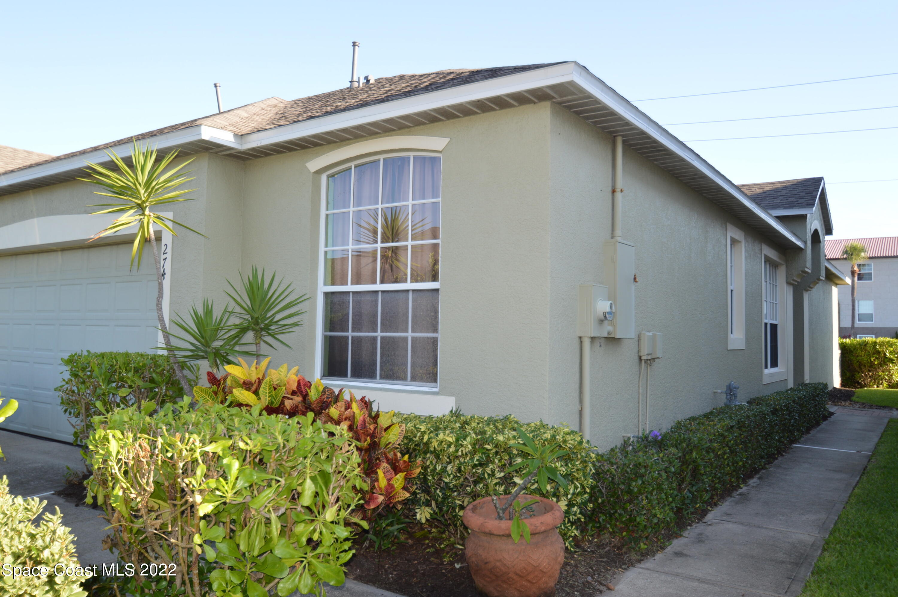 274 Intrepid Way Indialantic, FL 32903 - Photo 1 of 23 a house with a flower garden in front of it