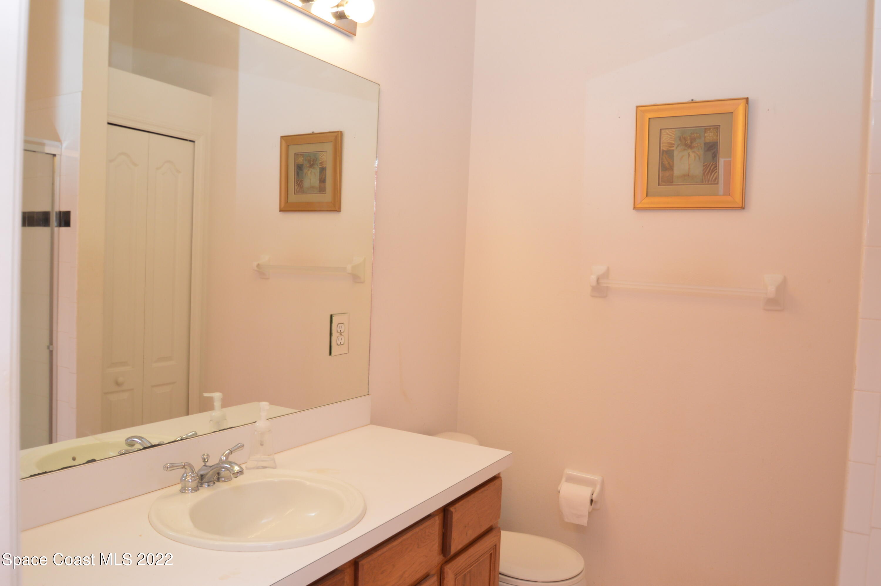 274 Intrepid Way Indialantic, FL 32903 - Photo 15 of 23 a bathroom with a sink and a mirror
