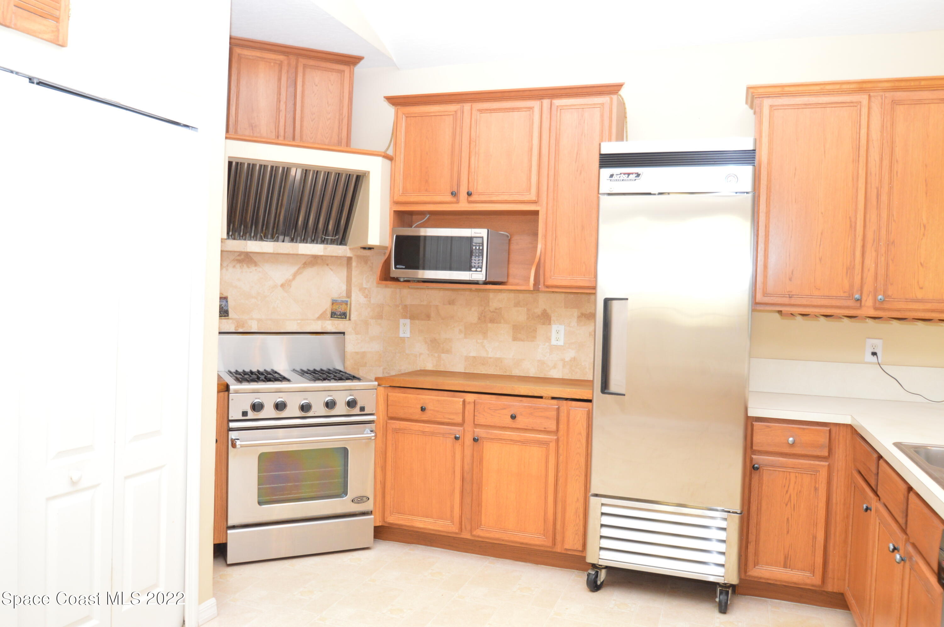 274 Intrepid Way Indialantic, FL 32903 - Photo 17 of 23 a kitchen with stainless steel appliances a stove a microwave and a refrigerator