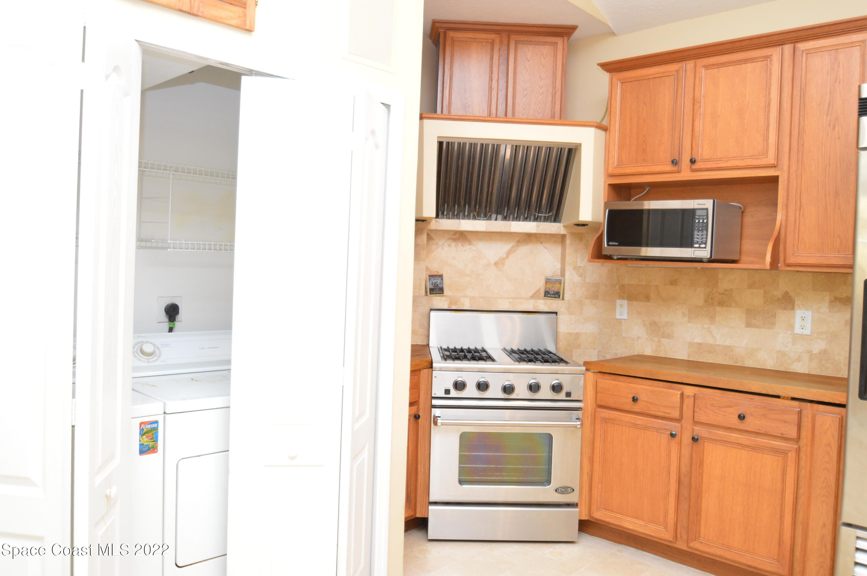 274 Intrepid Way Indialantic, FL 32903 - Photo 21 of 23 a kitchen with granite countertop a stove top oven microwave and cabinets