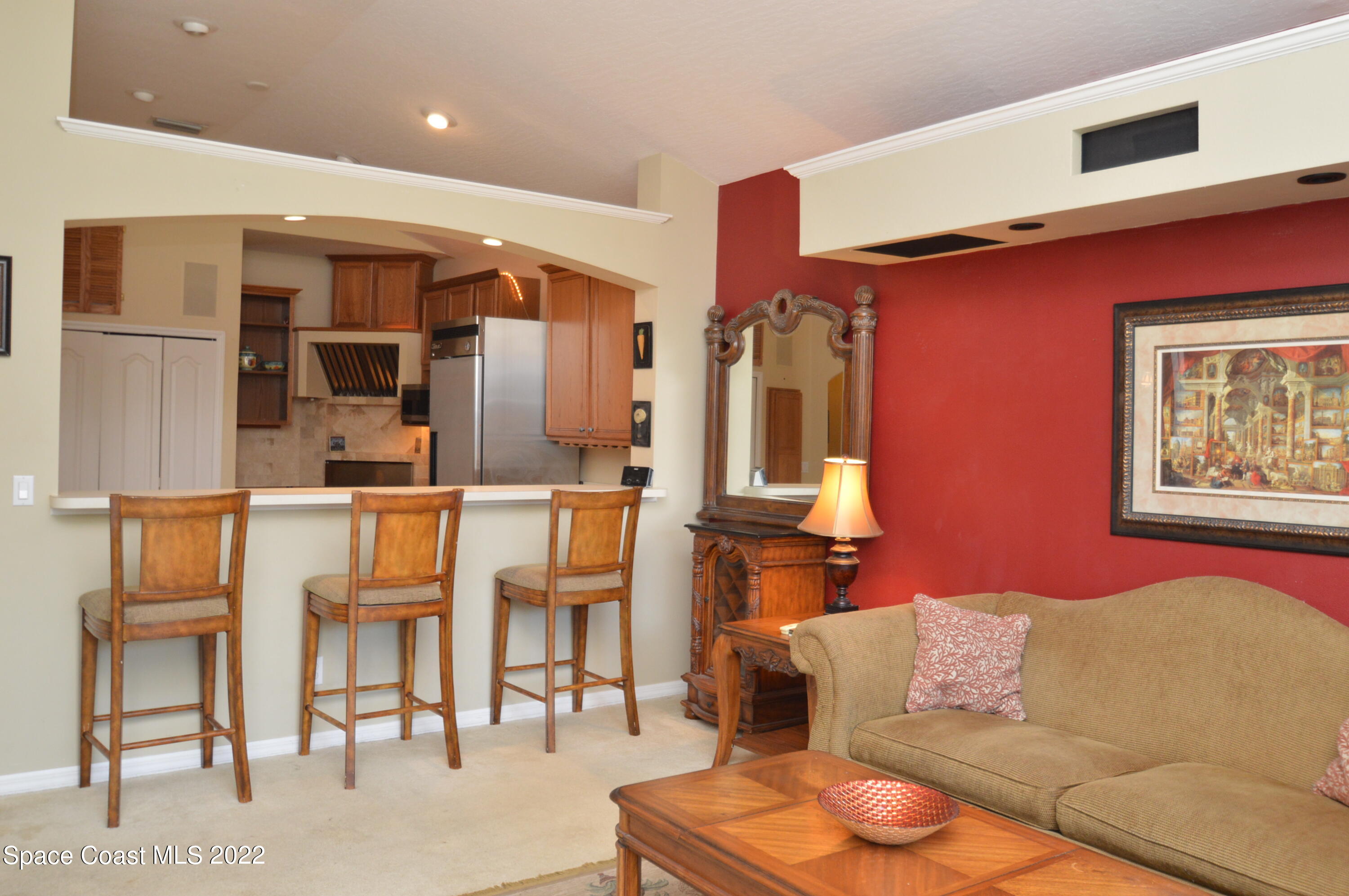 274 Intrepid Way Indialantic, FL 32903 - Photo 6 of 23 a living room with furniture a kitchen view and wooden floor