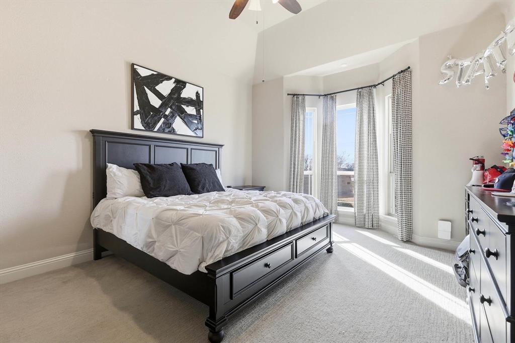 7751 Faught Road Northlake, TX 76226 - Photo 25 of 39 Spacious room featuring vaulted ceilings, a bay window with drapes, and neutral wall tones