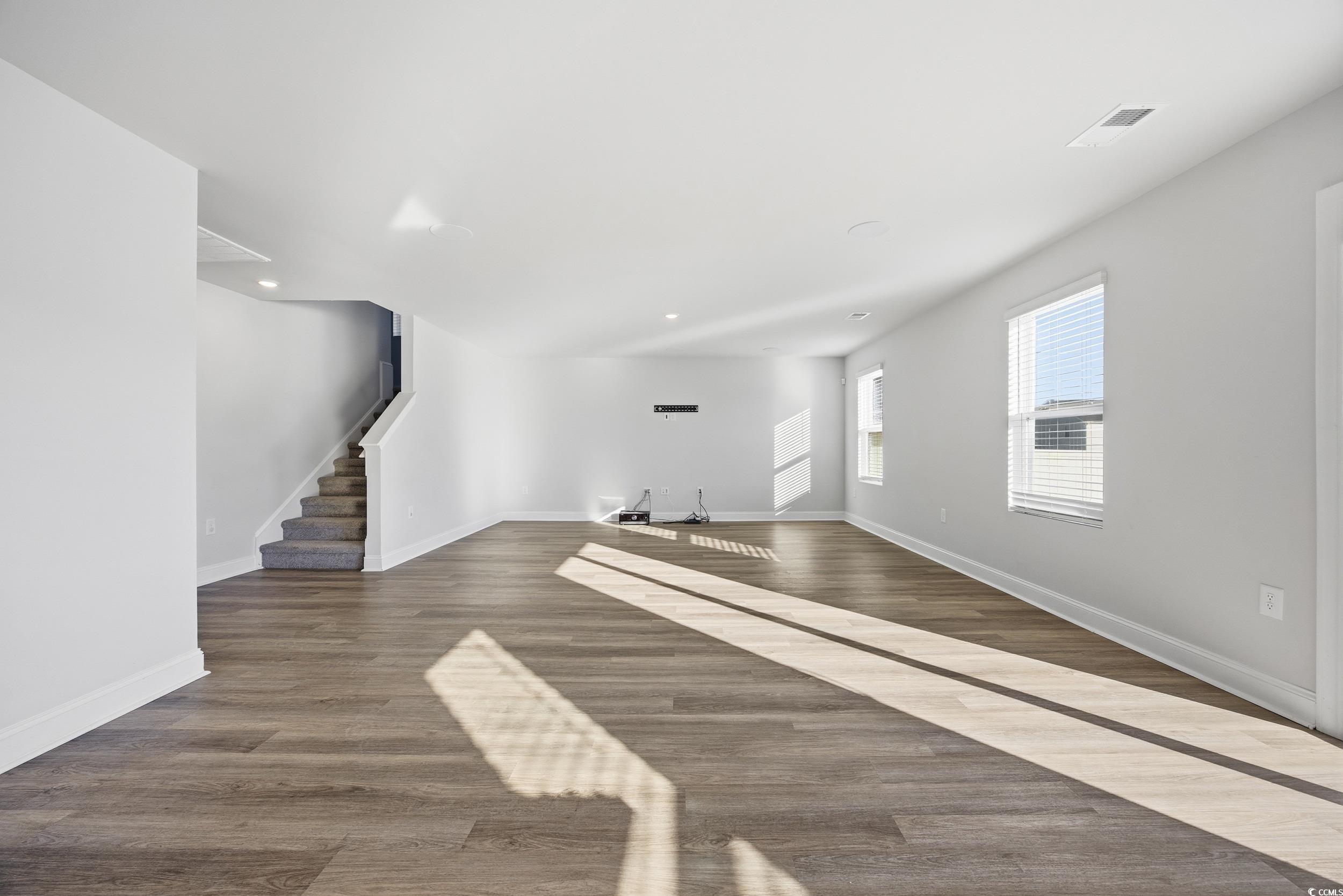 1052 Kinness Drive Conway, SC 29527 - Photo 12 of 38 Unfurnished living room with dark wood-type flooring, stairway, and recessed lighting