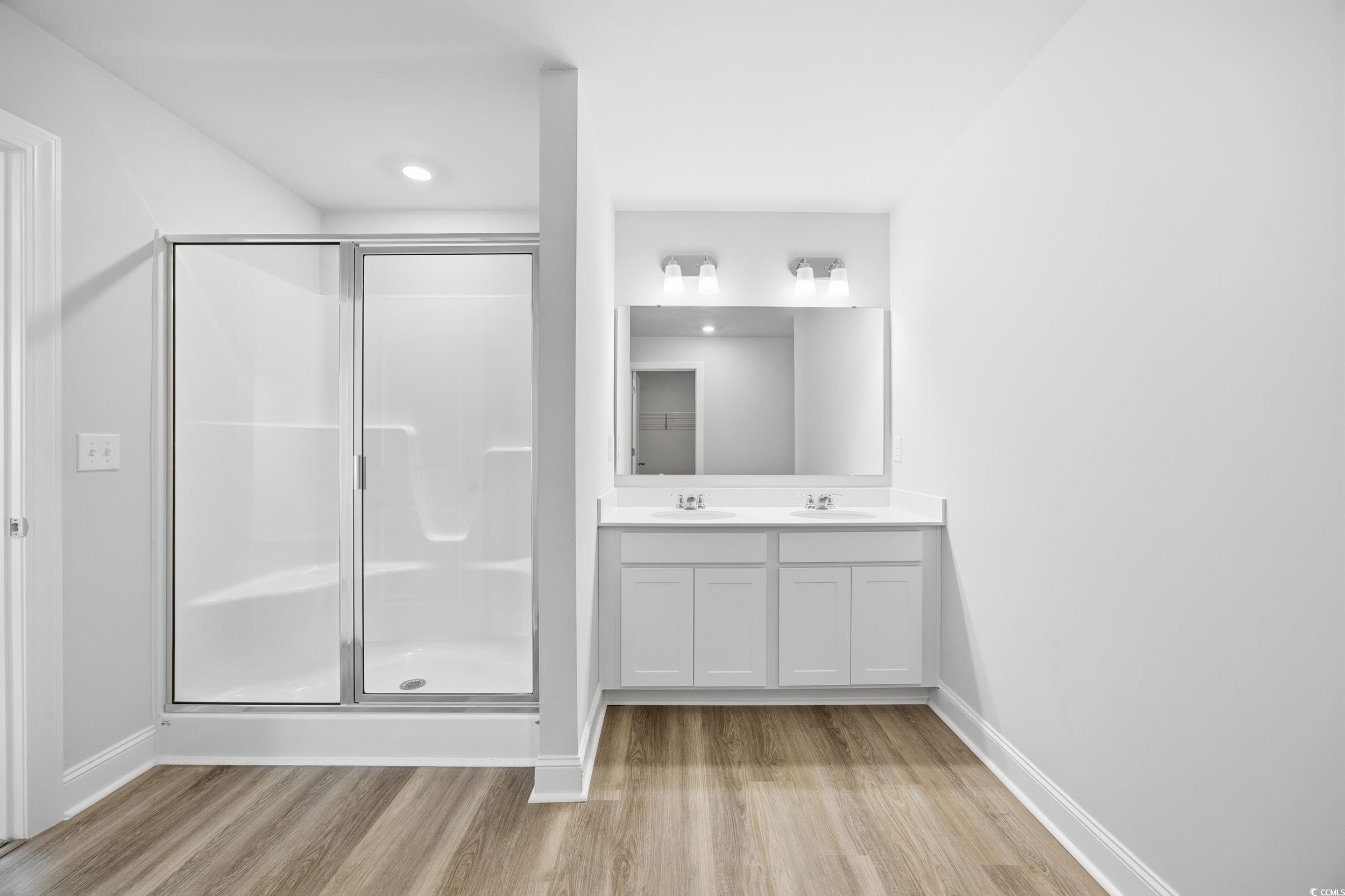 1052 Kinness Drive Conway, SC 29527 - Photo 19 of 38 Full bath with a stall shower, double vanity, and light wood-style floors