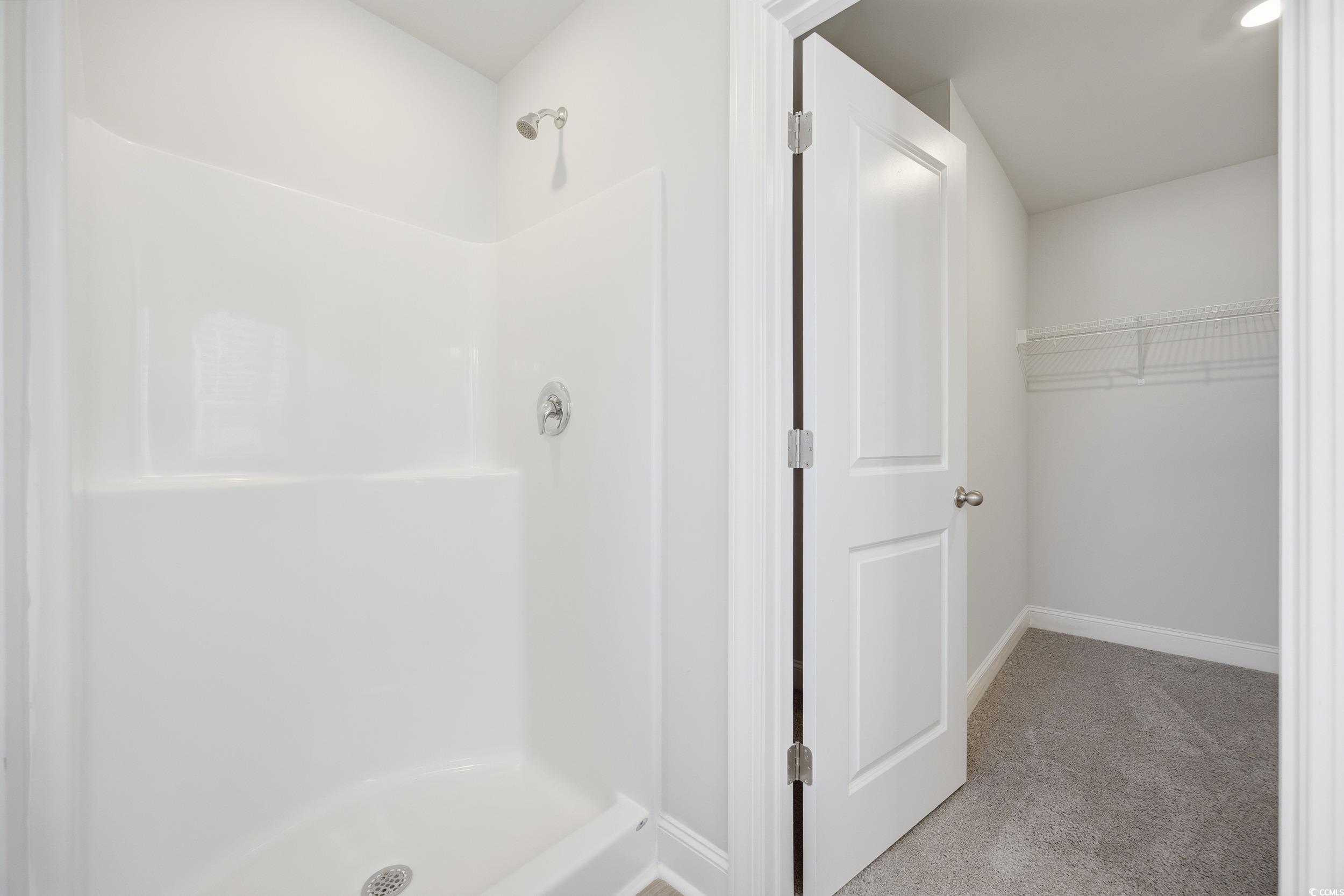 1052 Kinness Drive Conway, SC 29527 - Photo 23 of 38 Bathroom featuring light carpet, a shower stall, and a walk in closet