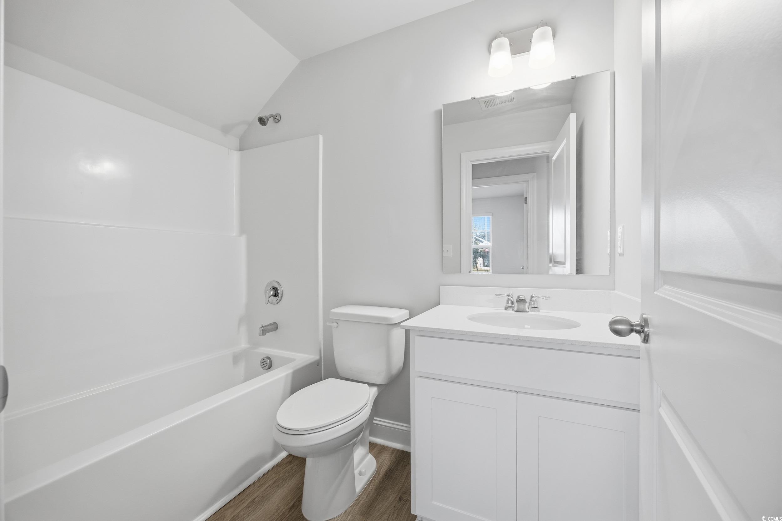 1052 Kinness Drive Conway, SC 29527 - Photo 6 of 38 Full bathroom featuring vanity, shower / bathtub combination, dark wood finished floors, and vaulted ceiling
