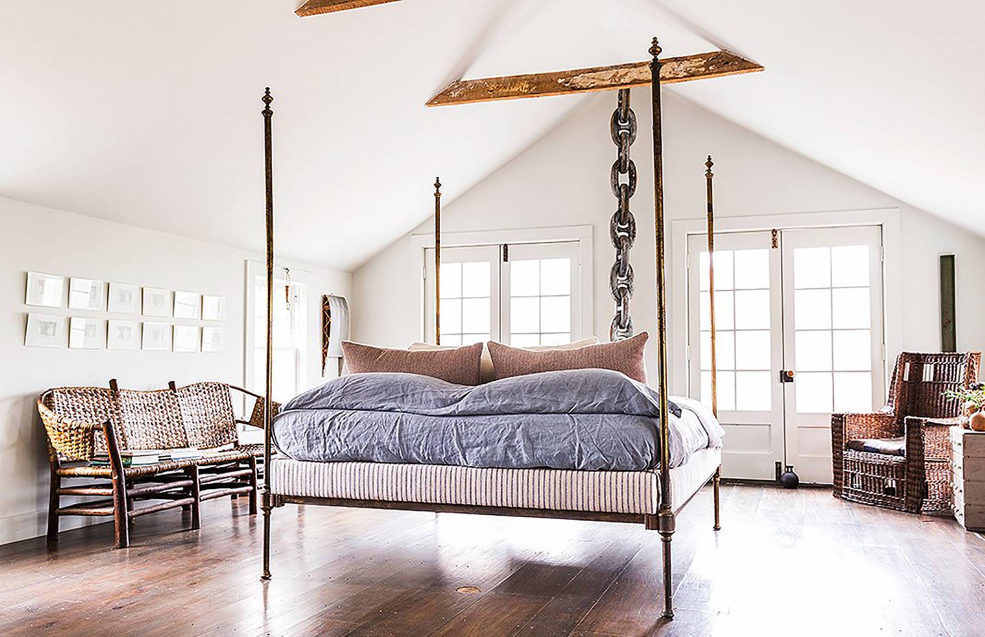 56 Sagaponack Road Bridgehampton, NY 11932 - Photo 12 of 23 a spacious bedroom with a bed a table and chair with the wooden floor