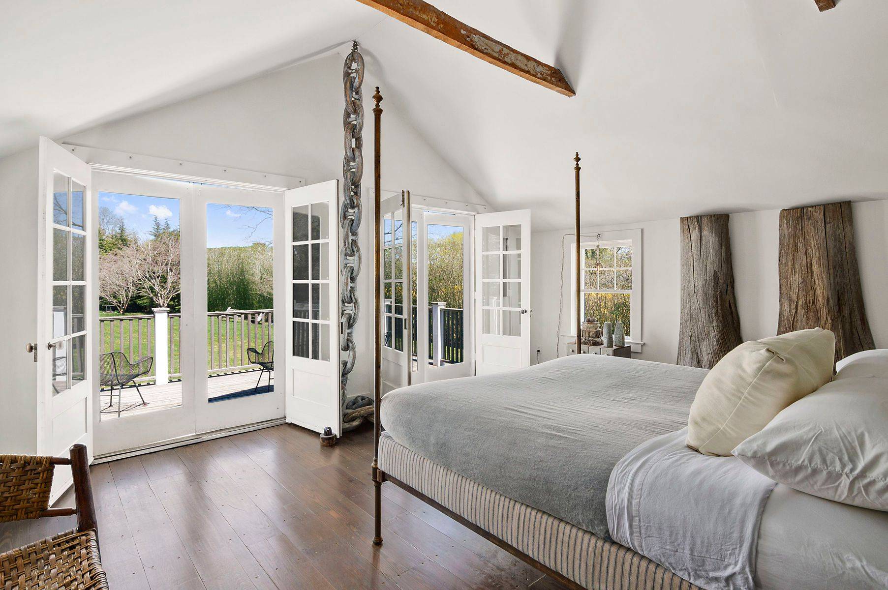 56 Sagaponack Road Bridgehampton, NY 11932 - Photo 13 of 23 a spacious bedroom with a large bed and glass door
