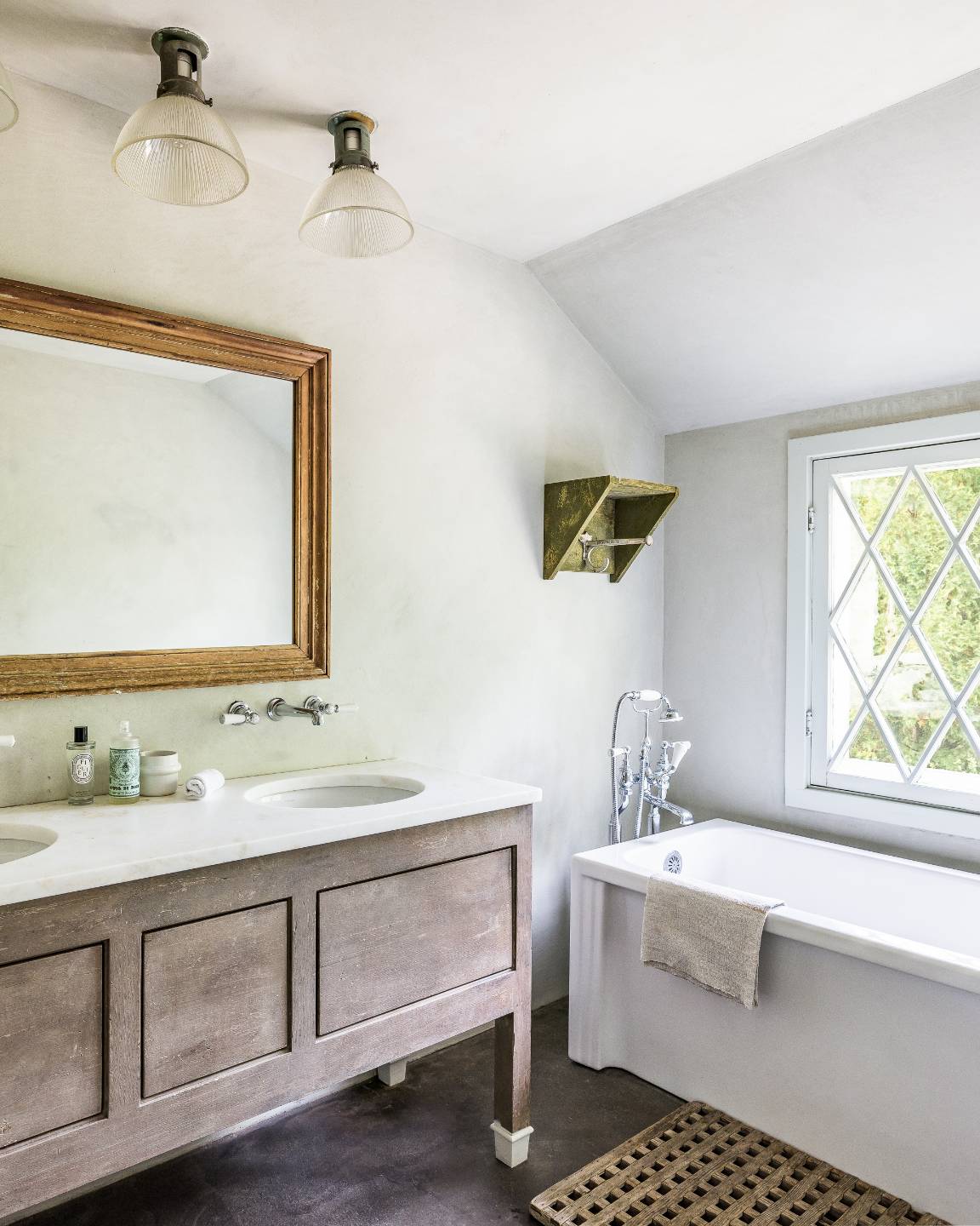 56 Sagaponack Road Bridgehampton, NY 11932 - Photo 14 of 23 a bathroom with a sink and a mirror
