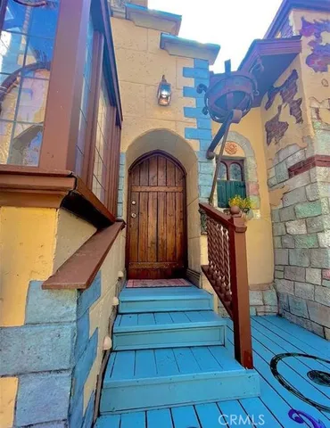 a front view of a house with wooden stairs