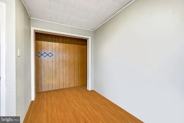 a view of a room with wooden floor and a window
