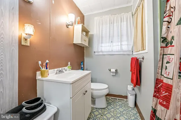 a bathroom with a sink toilet and a mirror