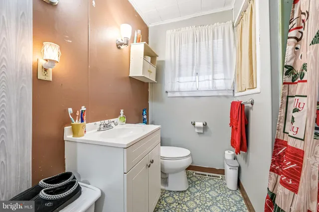 a bathroom with a sink toilet and a mirror