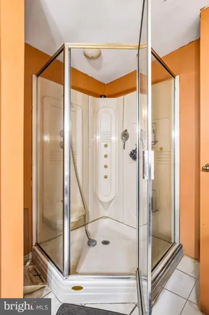 a bathroom with a glass shower door and a glass door