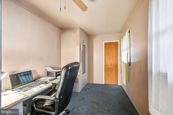 a view of workspace with wooden floor windows