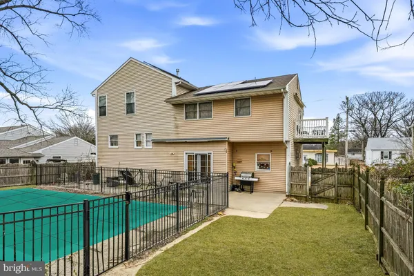 a view of a house with wooden fence
