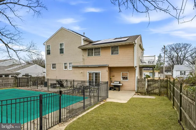 a view of a house with wooden fence