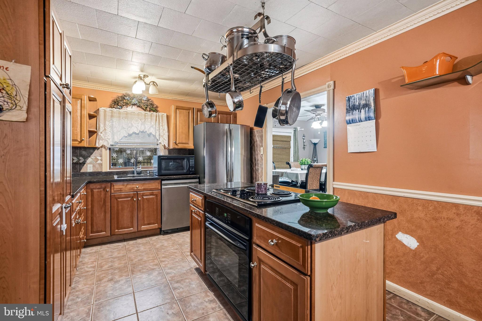 313 Ogden Station Road Wenonah, NJ 08090 - Photo 5 of 40 a kitchen with stainless steel appliances granite countertop a stove a sink dishwasher and a refrigerator with wooden floor