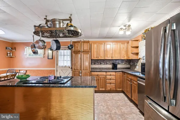 a kitchen with stainless steel appliances granite countertop a sink counter space and a window