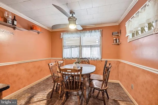 a view of a dining room with furniture and a chandelier