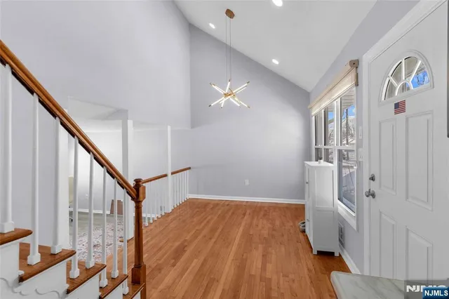 a view of entryway with wooden floor and stairs
