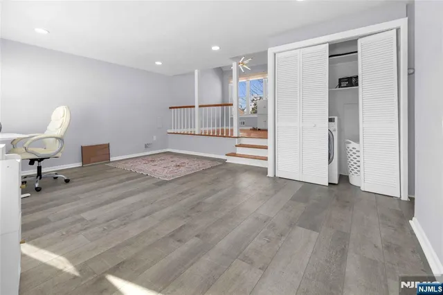 a view of a livingroom with wooden floor and a cabinet