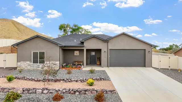 a front view of a house with a porch and outdoor seating