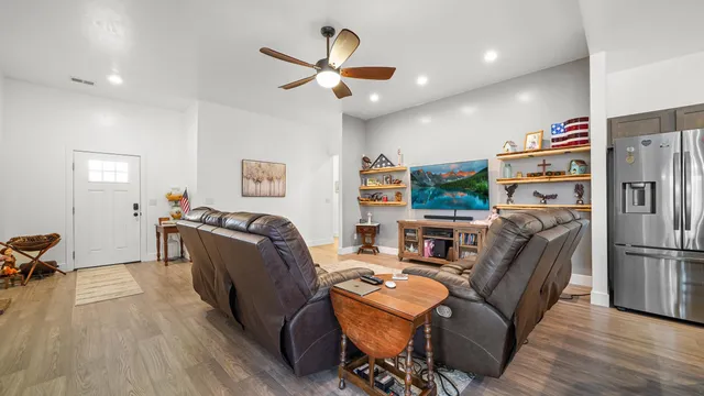 a kitchen with kitchen island a refrigerator and a stove top oven