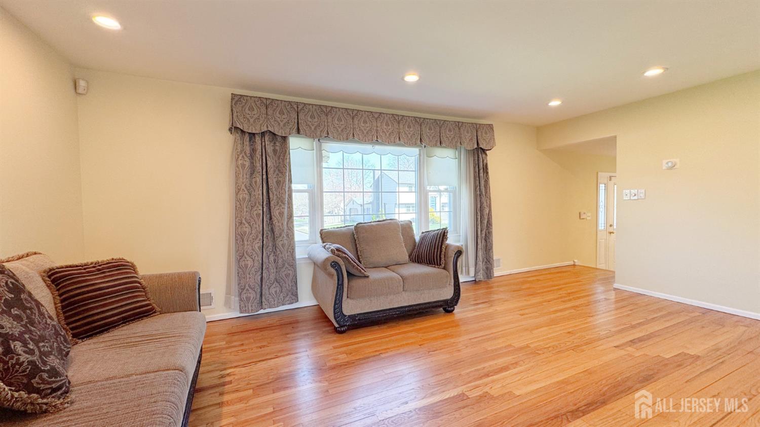 9 Stratford Circle Edison, NJ 08820 - Photo 11 of 38 a living room with furniture and a large window