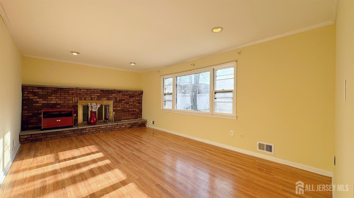 9 Stratford Circle Edison, NJ 08820 - Photo 13 of 38 a view of an empty room with a fireplace and a window