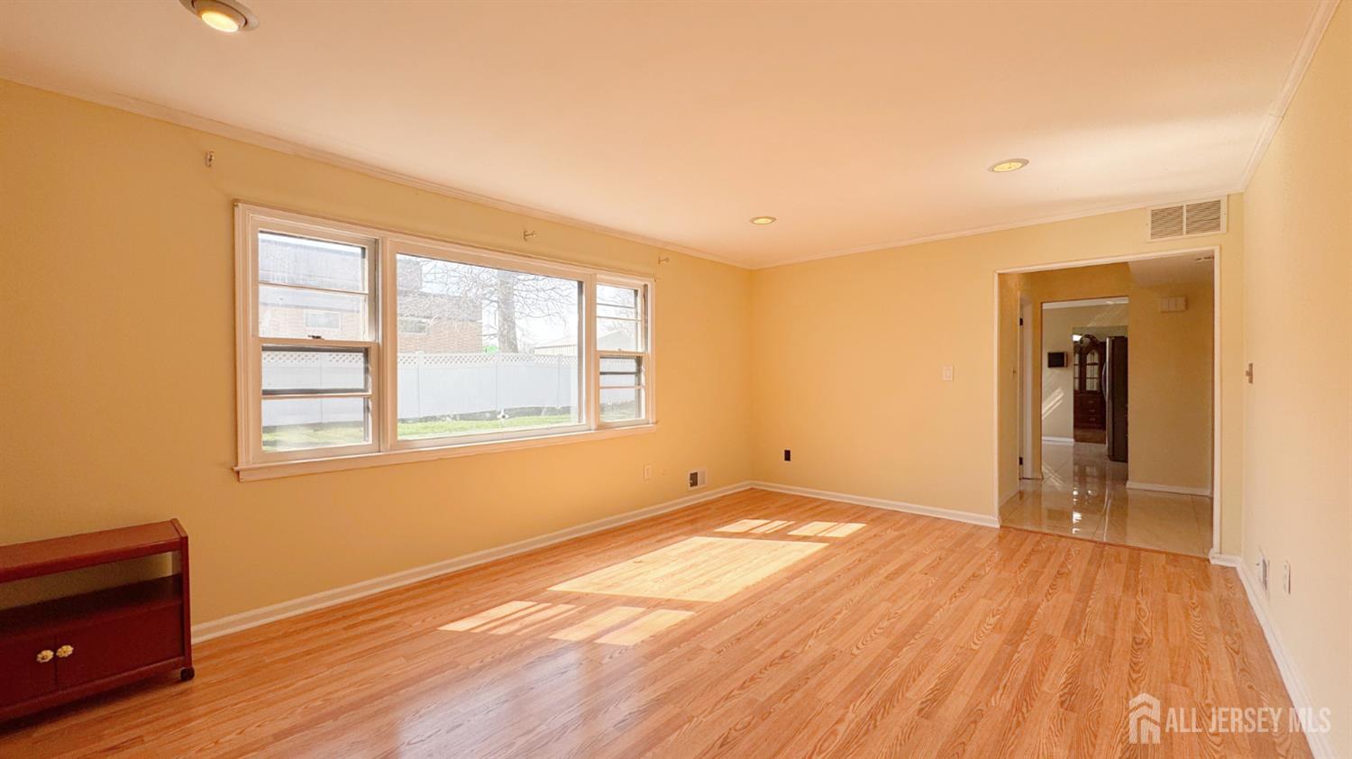 9 Stratford Circle Edison, NJ 08820 - Photo 14 of 38 a view of an empty room with wooden floor and a window