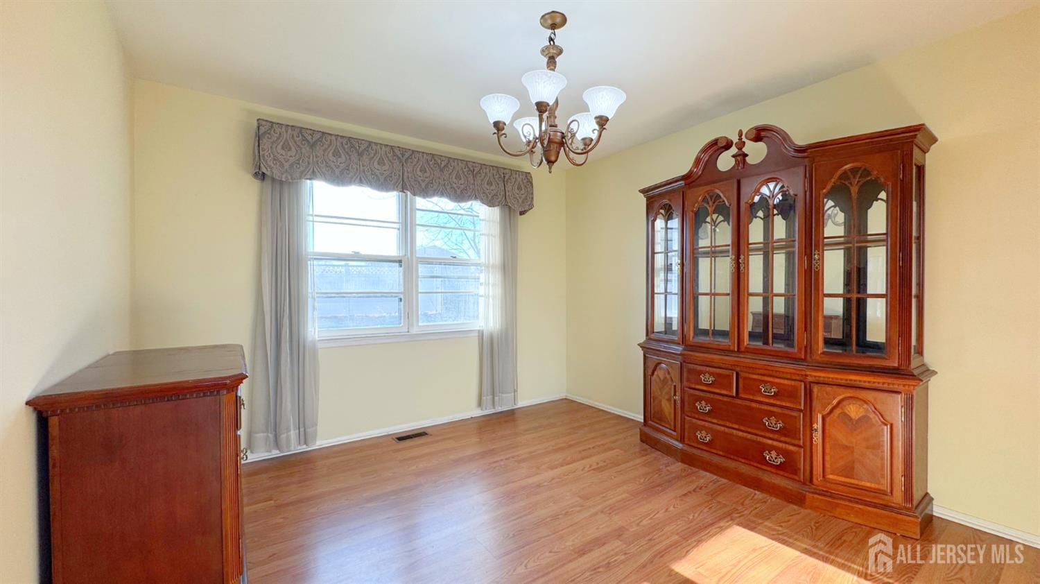 9 Stratford Circle Edison, NJ 08820 - Photo 16 of 38 a view of a livingroom with a large window wooden floor and cabinet