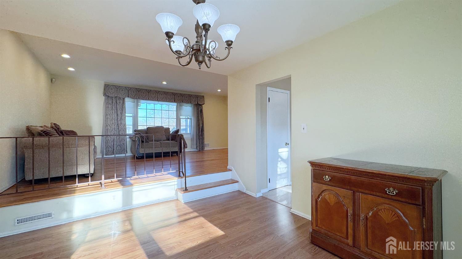 9 Stratford Circle Edison, NJ 08820 - Photo 17 of 38 a living room with furniture and a chandelier