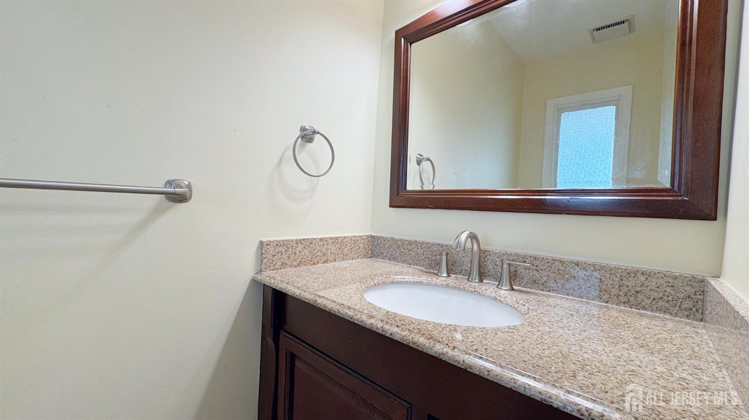 9 Stratford Circle Edison, NJ 08820 - Photo 23 of 38 a bathroom with a granite countertop sink and a mirror