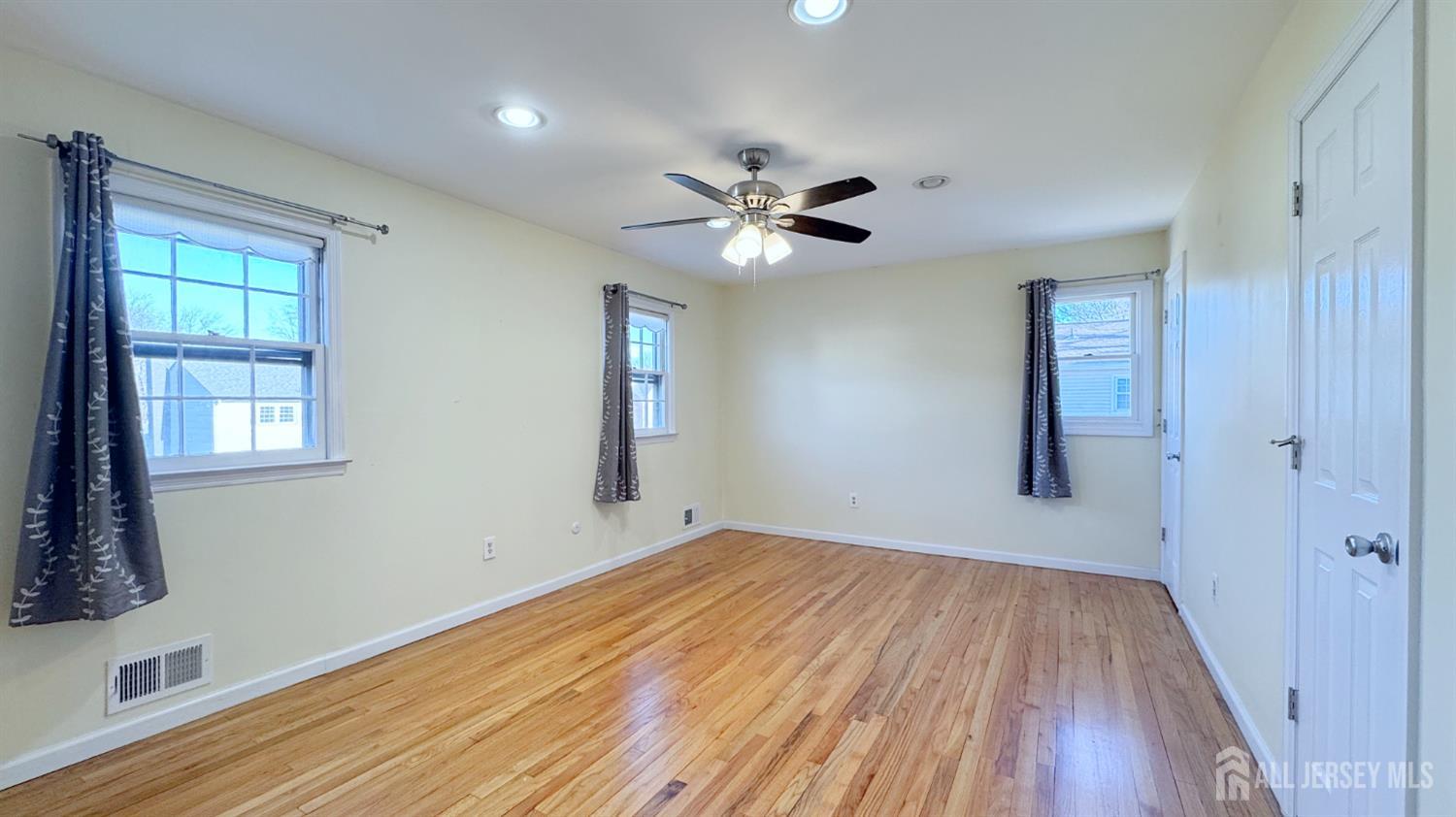 9 Stratford Circle Edison, NJ 08820 - Photo 28 of 38 a view of empty room with wooden floor and fan