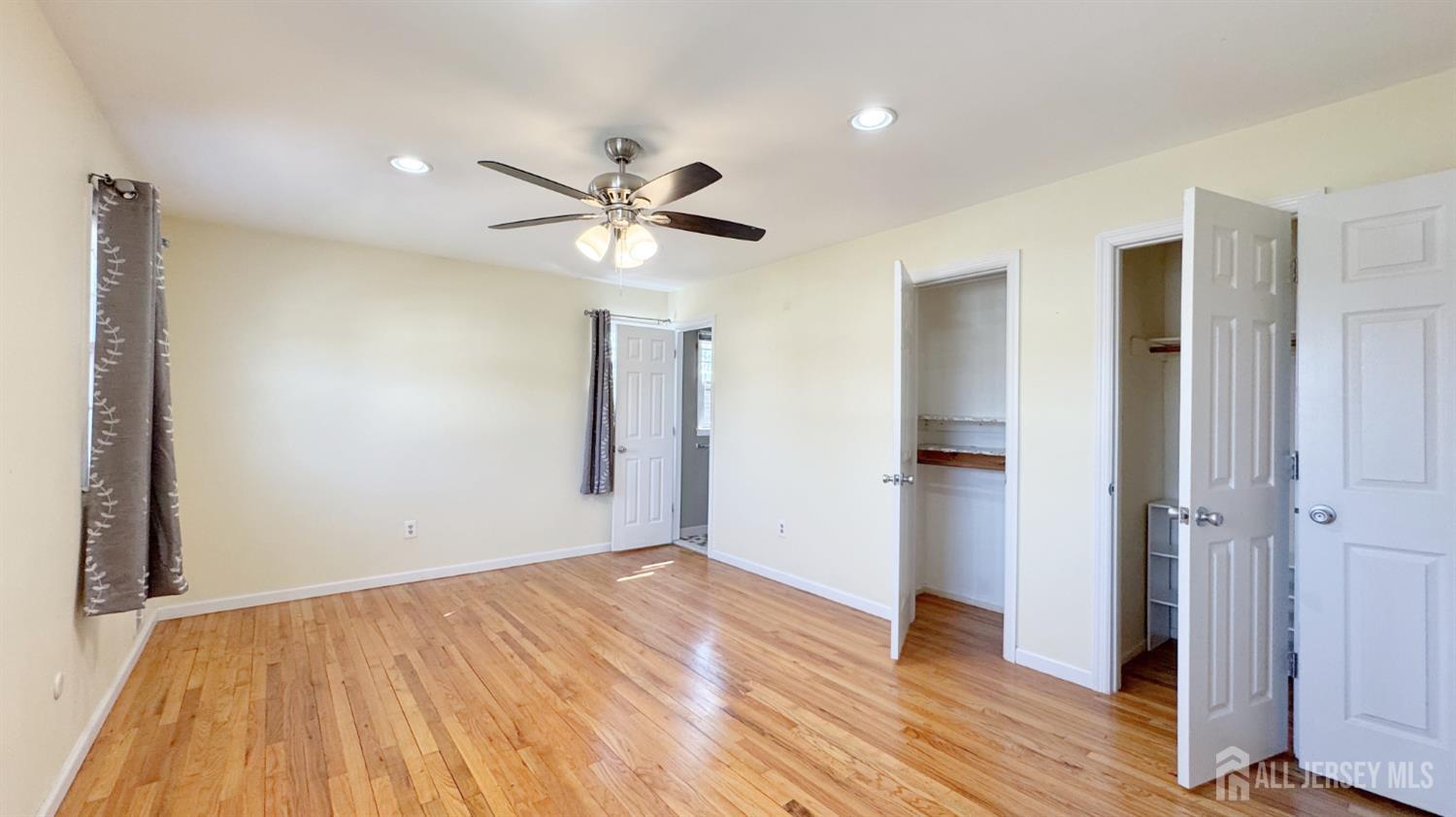 9 Stratford Circle Edison, NJ 08820 - Photo 29 of 38 an empty room with wooden floor and a ceiling fan