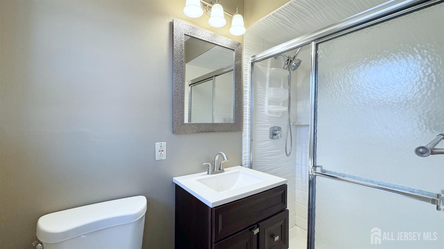 9 Stratford Circle Edison, NJ 08820 - Photo 30 of 38 a bathroom with a sink a toilet and shower