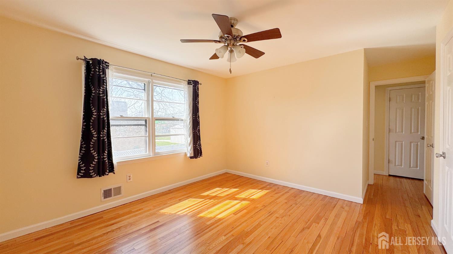 9 Stratford Circle Edison, NJ 08820 - Photo 32 of 38 a view of empty room with wooden floor and fan