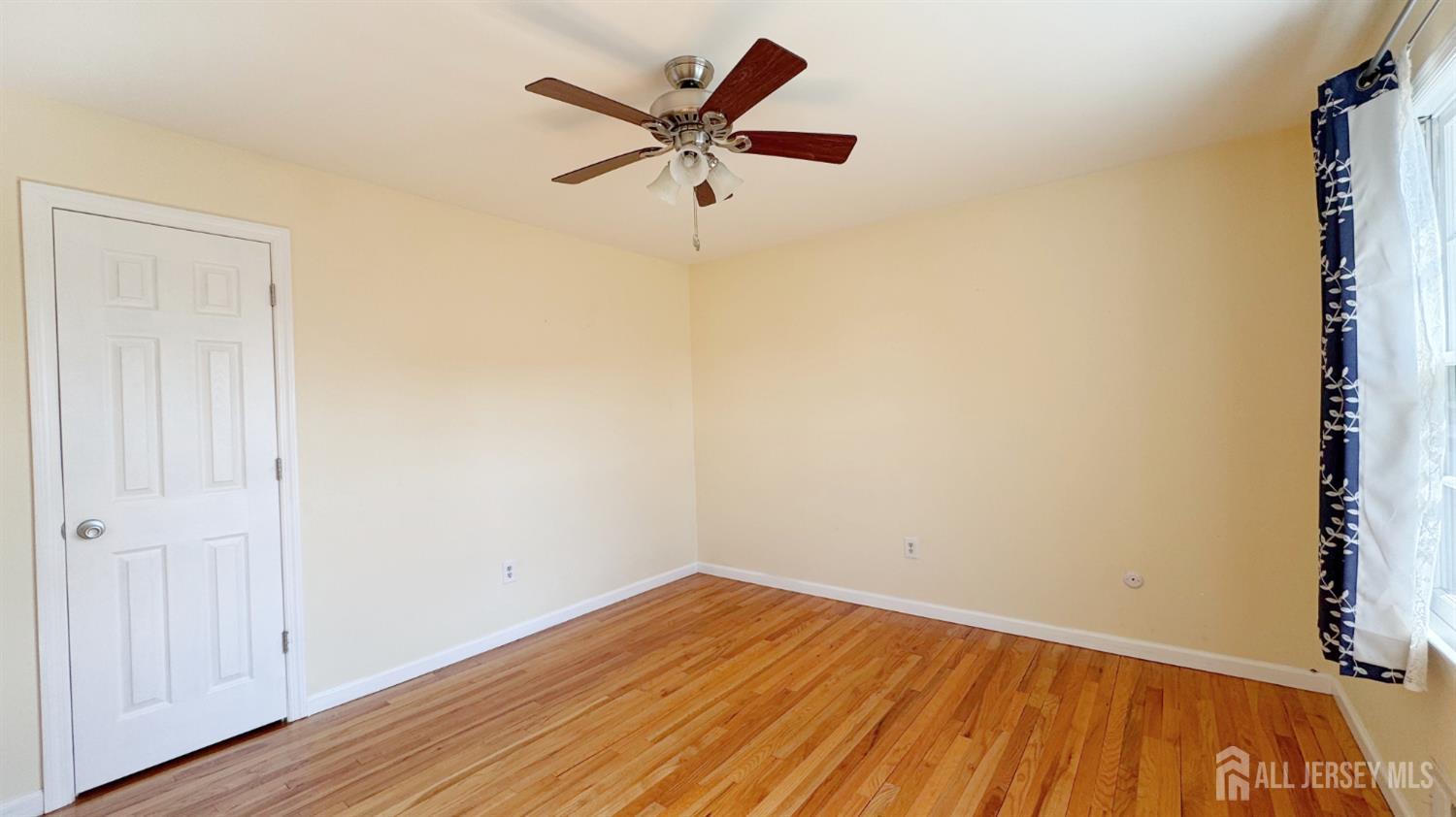 9 Stratford Circle Edison, NJ 08820 - Photo 33 of 38 an empty room with wooden floor and windows