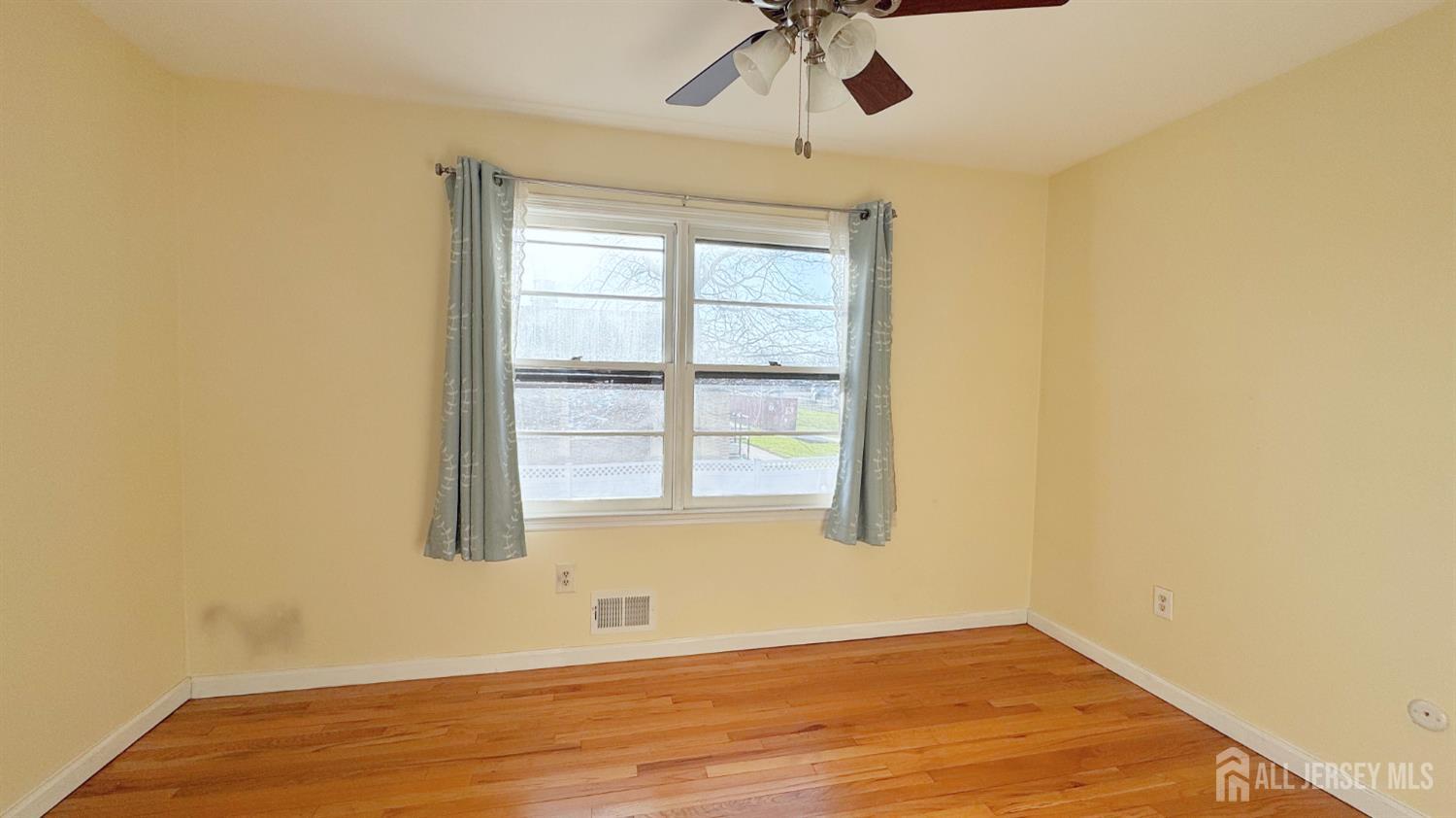9 Stratford Circle Edison, NJ 08820 - Photo 34 of 38 an empty room with a window and a ceiling fan