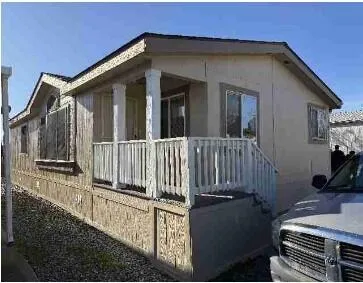 a view of a house with backyard and porch