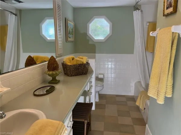 a dining room with furniture and a mirror