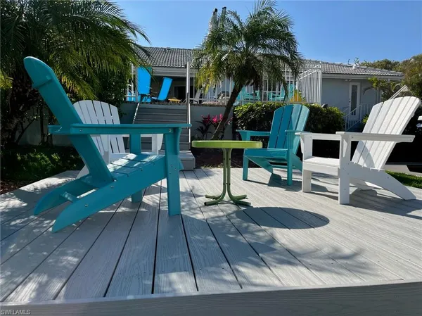 a view of a house with backyard porch and sitting area