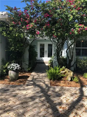a view of a house with a yard and garden